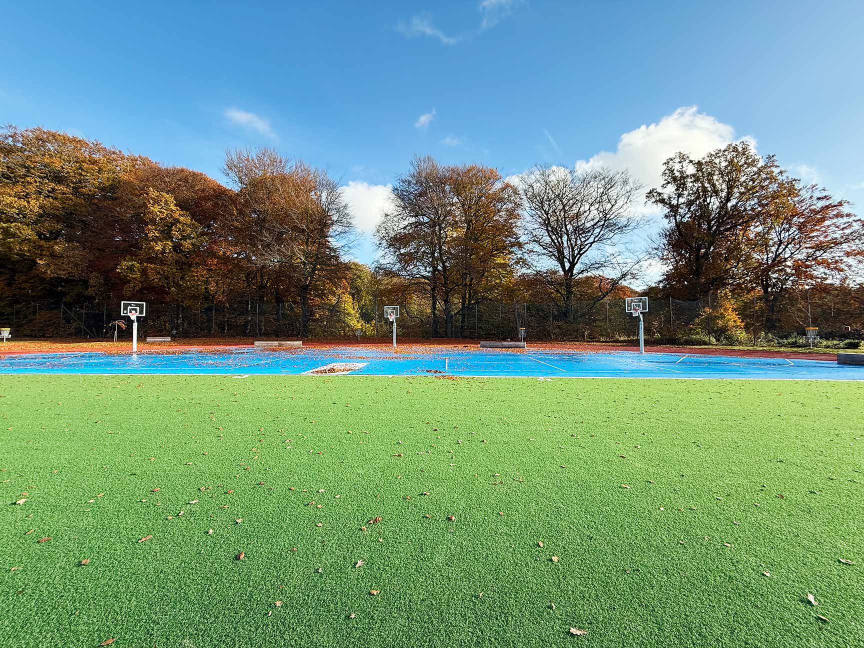 Aktivitetsområde ved skole med boldbane, basketballbane og løbebane til atletik